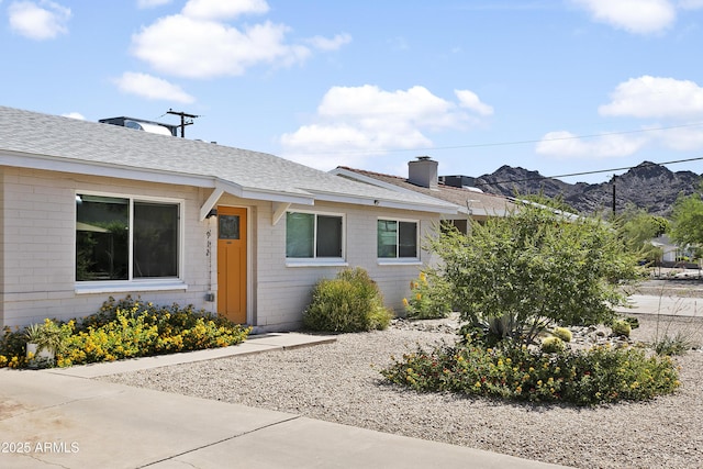 912 E Orchid Ln, Phoenix, AZ 85020 - entrance to property with a shingled roof, a chimney, and a mountain view