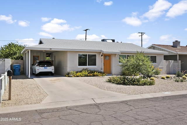 912 E Orchid Ln, Phoenix, AZ 85020 - single story home with concrete driveway, a carport, brick siding, and roof with shingles