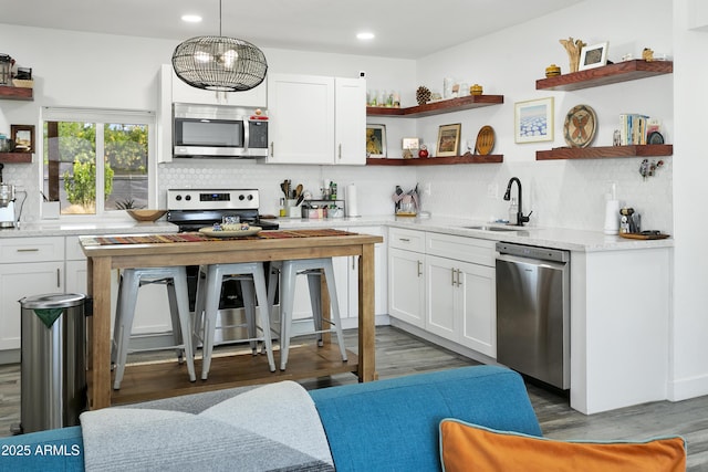 912 E Orchid Ln, Phoenix, AZ 85020 - kitchen with appliances with stainless steel finishes, open shelves, decorative backsplash, recessed lighting, and white cabinetry