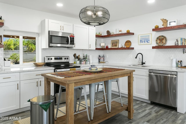 912 E Orchid Ln, Phoenix, AZ 85020 - kitchen featuring appliances with stainless steel finishes, open shelves, decorative backsplash, white cabinets, and recessed lighting