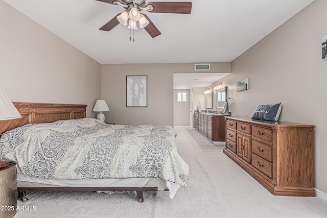 bedroom with light colored carpet, ceiling fan, visible vents, and baseboards