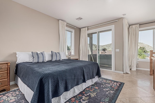 bedroom with baseboards, visible vents, and access to exterior