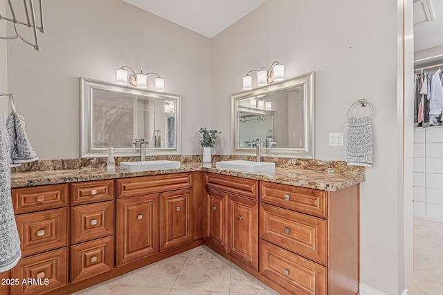 full bathroom featuring a sink, tile patterned flooring, and double vanity