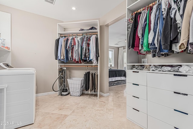 walk in closet featuring washer / dryer and light tile patterned floors