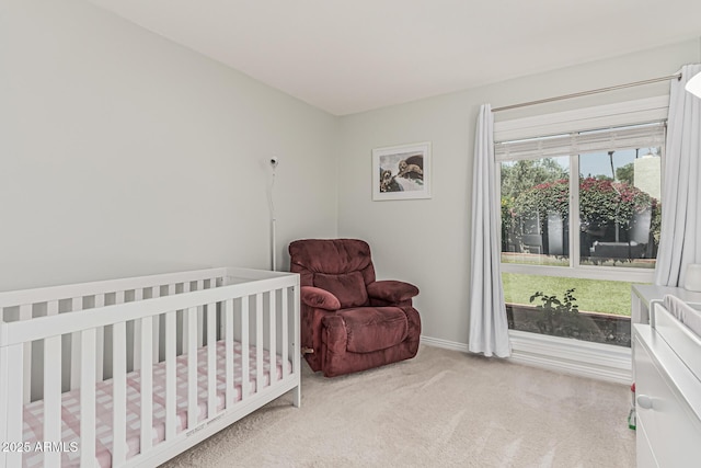 bedroom featuring carpet floors and a nursery area