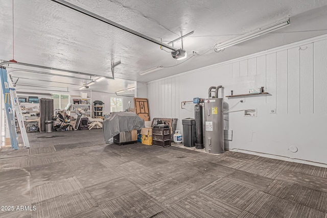garage featuring a garage door opener and water heater