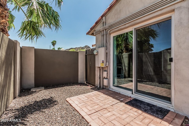 view of patio featuring fence and a gate