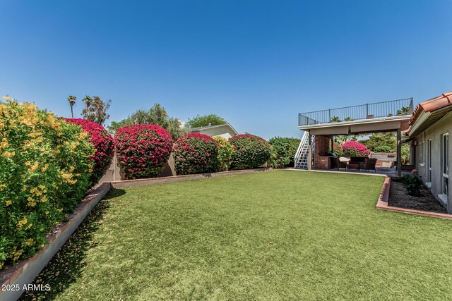 view of yard featuring a fenced backyard, a patio area, and stairway
