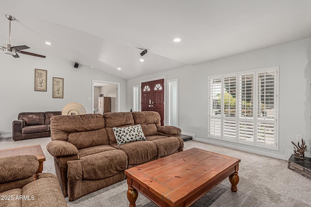 living room featuring light colored carpet, baseboards, ceiling fan, and lofted ceiling