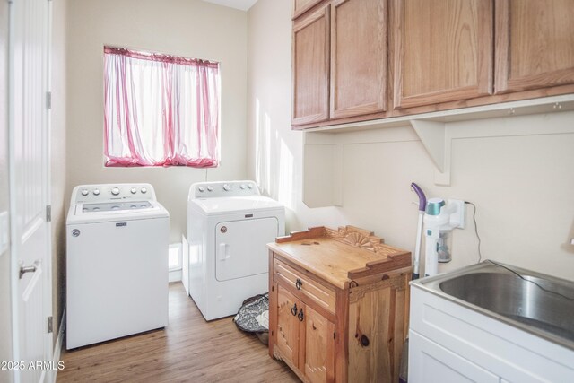 6317 E Beckett Trl, Prescott Valley, AZ 86314 - laundry room featuring washer and clothes dryer, a sink, cabinet space, and light wood-style floors