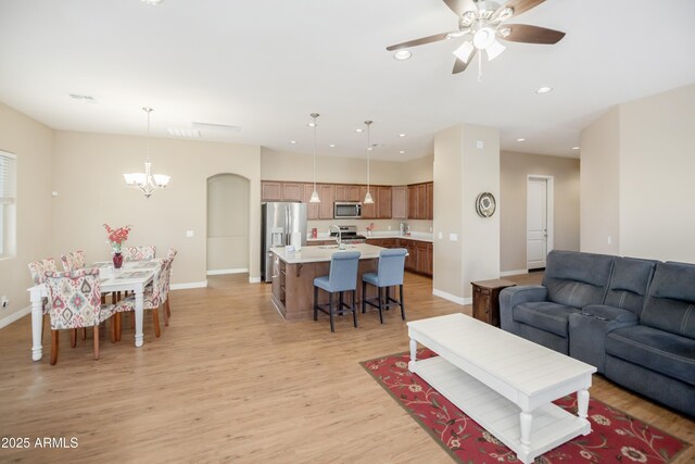 6317 E Beckett Trl, Prescott Valley, AZ 86314 - living room featuring light wood-style flooring, ceiling fan with notable chandelier, baseboards, and recessed lighting
