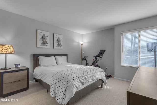 bedroom featuring light carpet