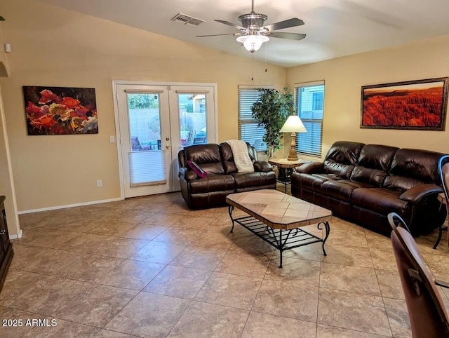 living room featuring lofted ceiling, a wealth of natural light, ceiling fan, and french doors