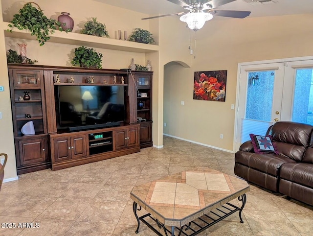 living room featuring ceiling fan and french doors