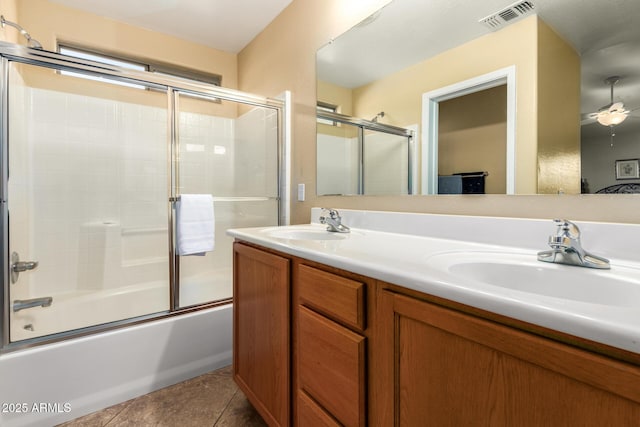 bathroom featuring ceiling fan, tile patterned floors, bath / shower combo with glass door, and vanity