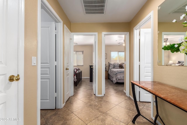 hall with light tile patterned flooring