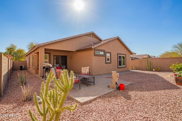 rear view of house with cooling unit and a patio area