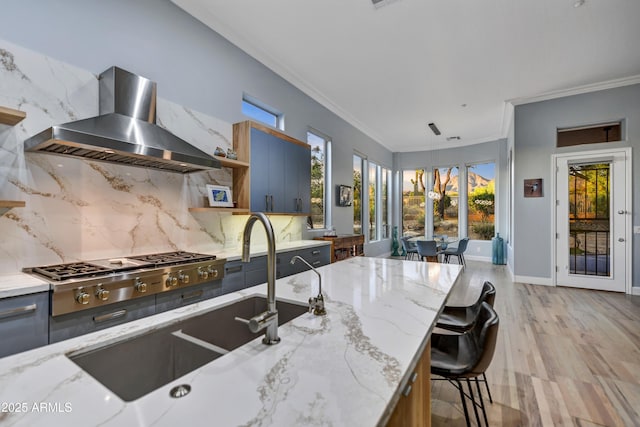 kitchen featuring crown molding, decorative backsplash, open shelves, stainless steel gas cooktop, and wall chimney exhaust hood