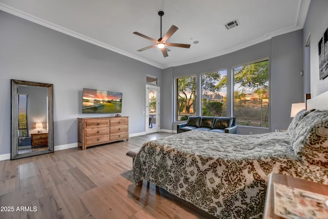 bedroom with access to outside, visible vents, wood finished floors, baseboards, and ornamental molding