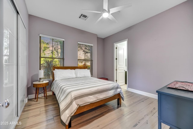 bedroom featuring ceiling fan, visible vents, baseboards, a closet, and light wood-style floors