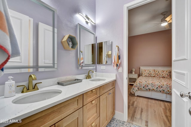 ensuite bathroom featuring double vanity, a sink, ceiling fan, and ensuite bathroom