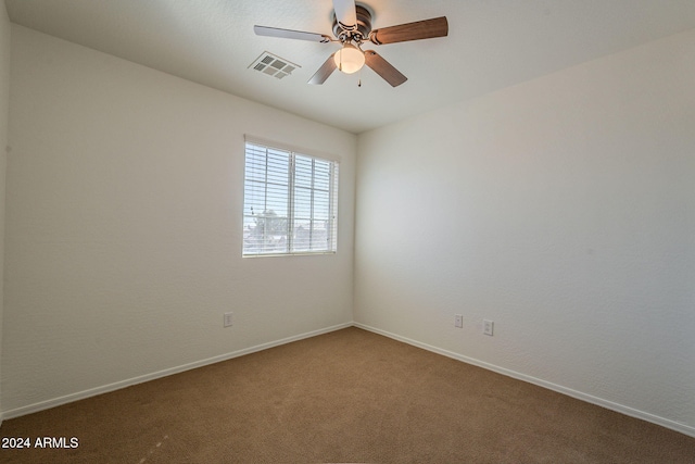 carpeted spare room with ceiling fan