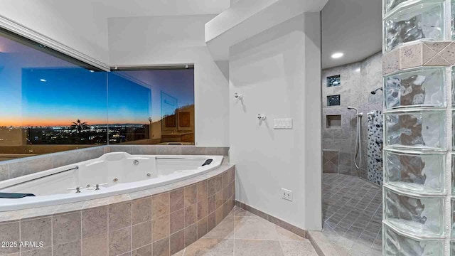 bathroom with tile patterned floors and shower with separate bathtub