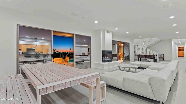 living room featuring a multi sided fireplace