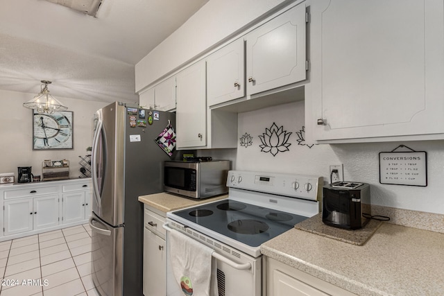 kitchen with appliances with stainless steel finishes, a chandelier, pendant lighting, and white cabinets