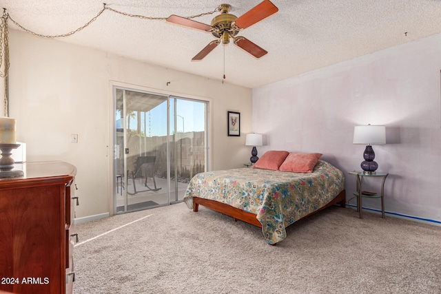 carpeted bedroom featuring a textured ceiling, access to exterior, and ceiling fan