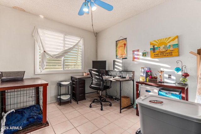 tiled office space featuring a textured ceiling and ceiling fan