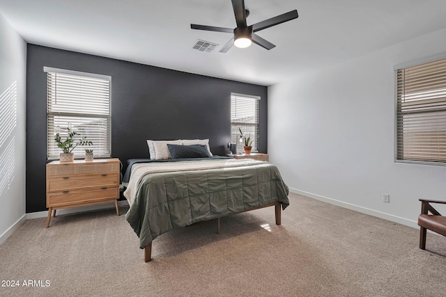 bedroom with baseboards, visible vents, ceiling fan, and carpet flooring