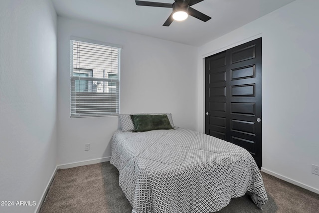 bedroom featuring baseboards, dark carpet, and ceiling fan