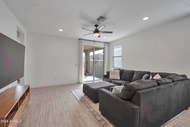 living room with baseboards, light wood finished floors, visible vents, and recessed lighting