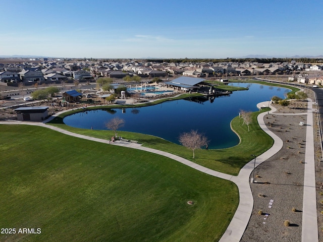 birds eye view of property with a water view and a residential view