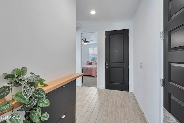 interior space featuring baseboards and light wood-style floors