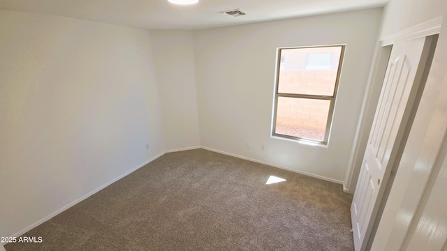 unfurnished room featuring carpet, baseboards, and visible vents