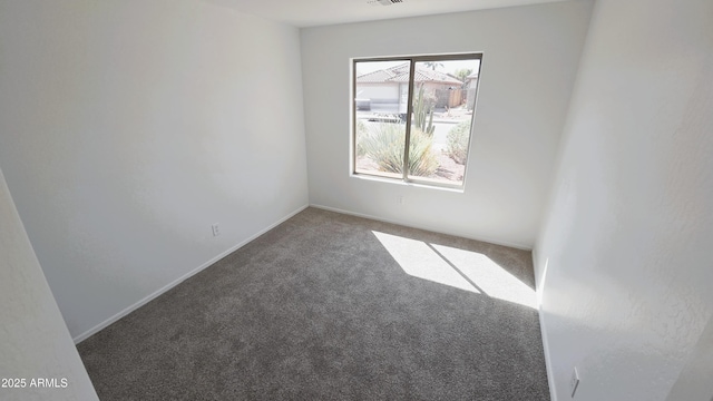 carpeted spare room featuring visible vents
