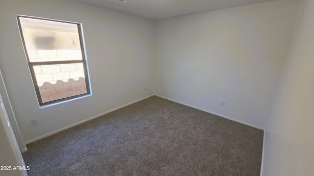 carpeted empty room with baseboards