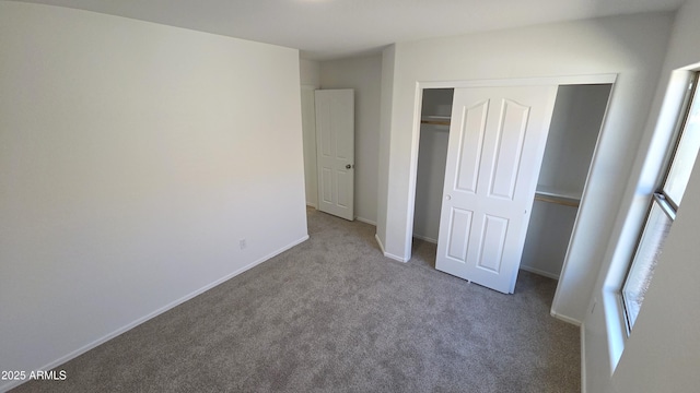 unfurnished bedroom featuring a closet, carpet flooring, and baseboards