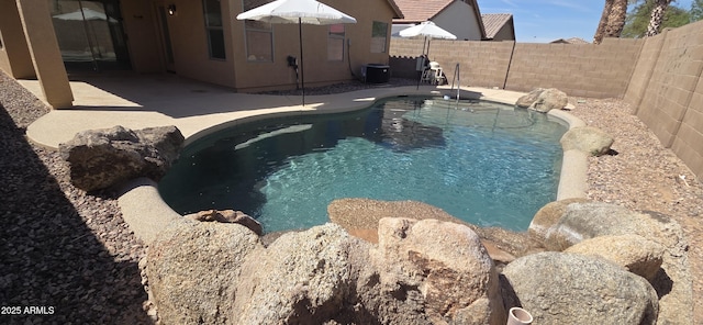 view of pool with a fenced backyard, a fenced in pool, and a patio area
