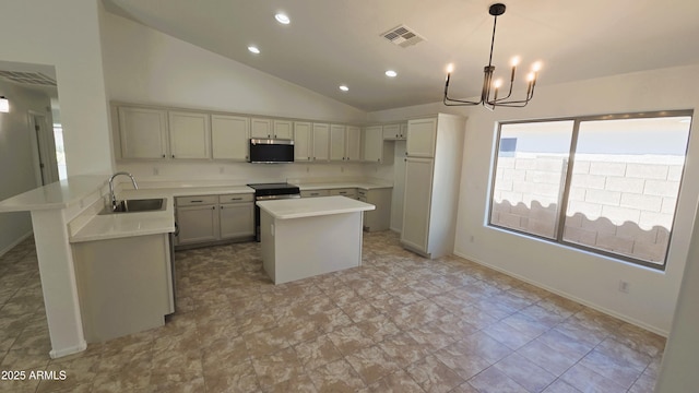 kitchen with stainless steel microwave, a sink, visible vents, a peninsula, and a notable chandelier
