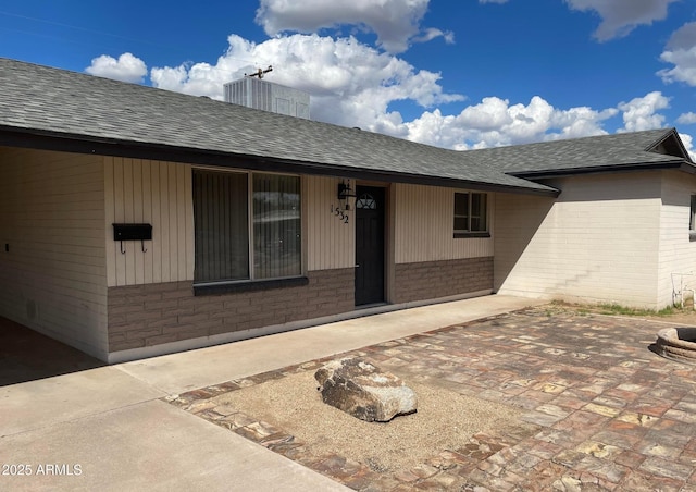 1532 W 6th St, Tempe, AZ 85281 - property entrance featuring brick siding, a shingled roof, and a patio area