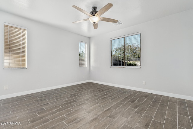 empty room featuring ceiling fan and dark hardwood / wood-style flooring