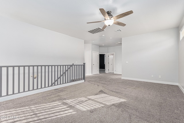 carpeted spare room with ceiling fan