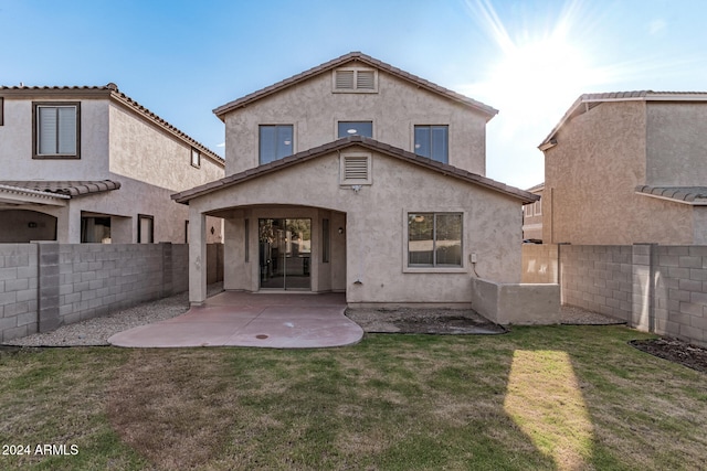 back of house featuring a patio area and a yard