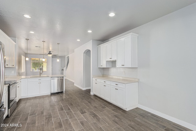 kitchen featuring ceiling fan, pendant lighting, white cabinets, and stainless steel appliances