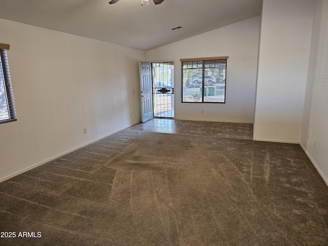 carpeted spare room featuring lofted ceiling and ceiling fan