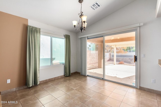 doorway to outside featuring a wealth of natural light, light tile patterned floors, lofted ceiling, and a chandelier