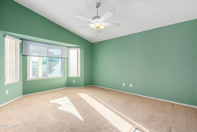 unfurnished room with light carpet, ceiling fan, and vaulted ceiling